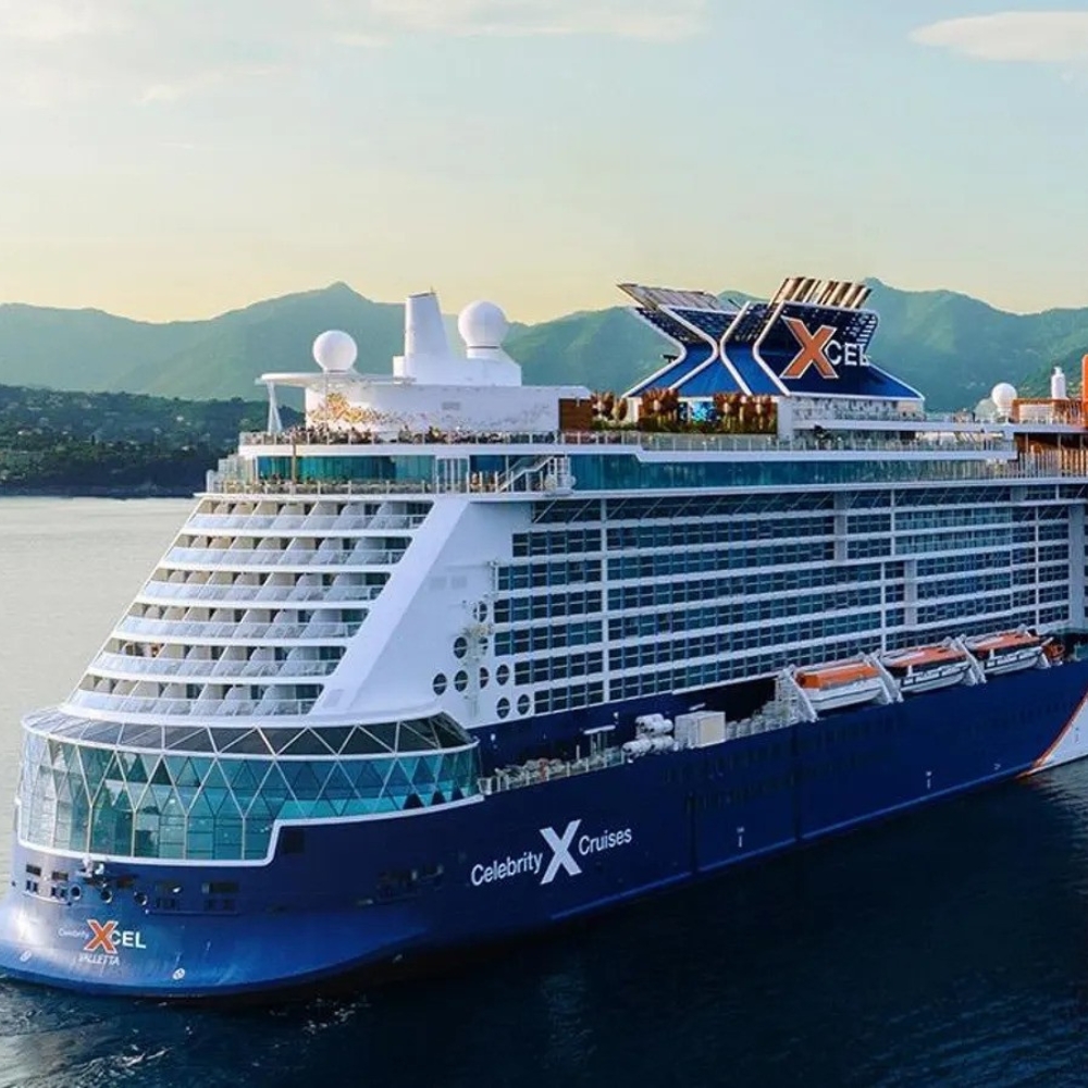 Cruise ship in the water with mountains in the background